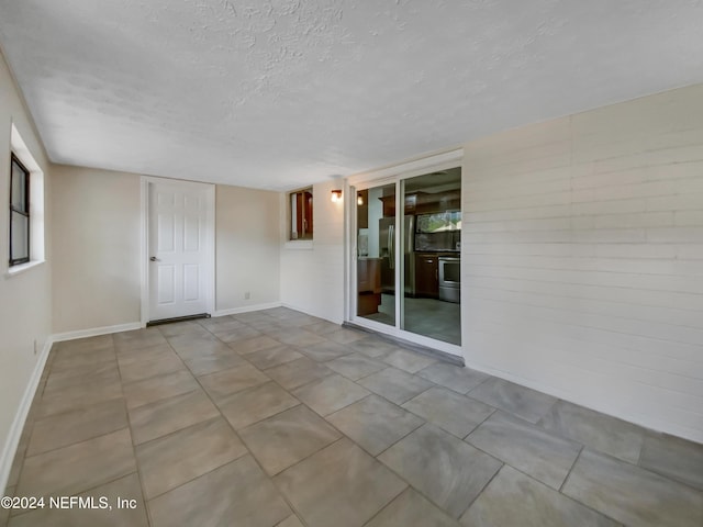 spare room featuring a textured ceiling