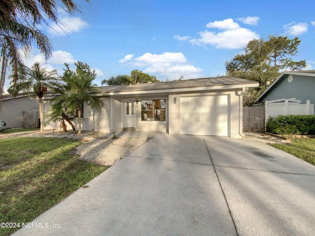 view of front of property with a front yard and a garage