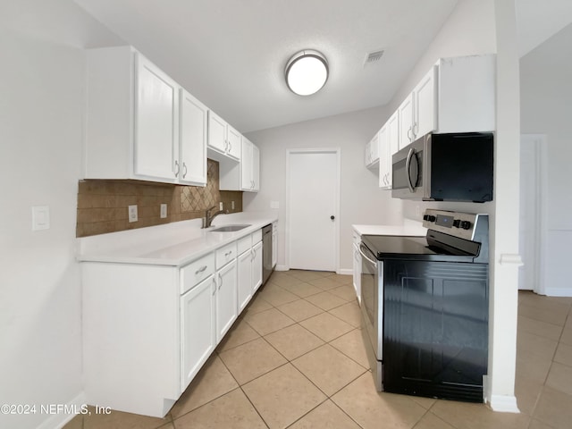 kitchen featuring appliances with stainless steel finishes, light tile patterned floors, and white cabinetry