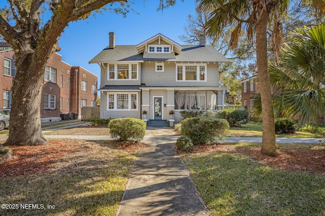 view of front of home featuring cooling unit and a front yard