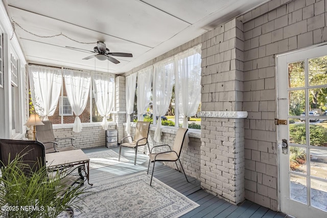 sunroom featuring ceiling fan