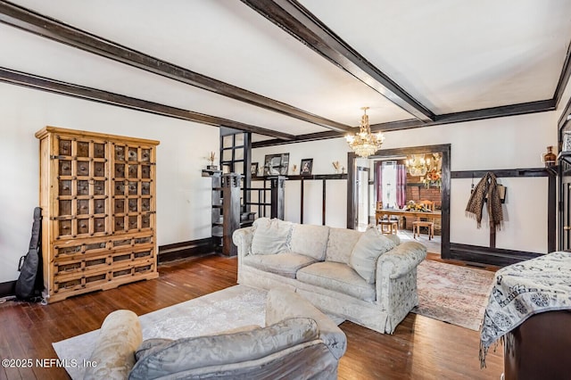 living room with beamed ceiling, dark hardwood / wood-style floors, and a chandelier