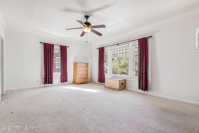 unfurnished room featuring ceiling fan, light colored carpet, and crown molding