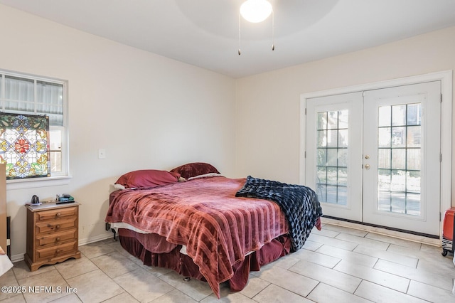 tiled bedroom with access to outside, ceiling fan, and french doors