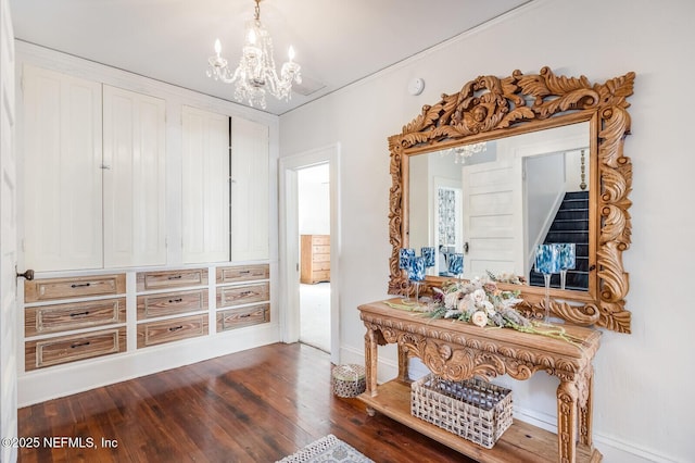 interior space featuring a chandelier and dark hardwood / wood-style floors