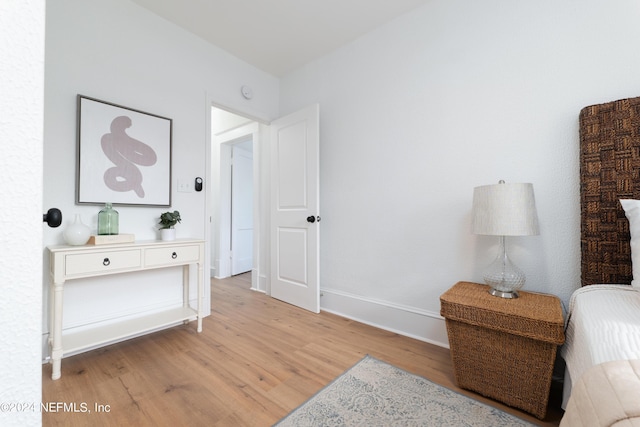 bedroom featuring light wood-style flooring and baseboards