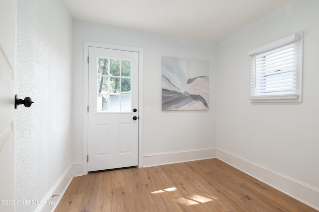 entryway with light wood-style flooring and baseboards