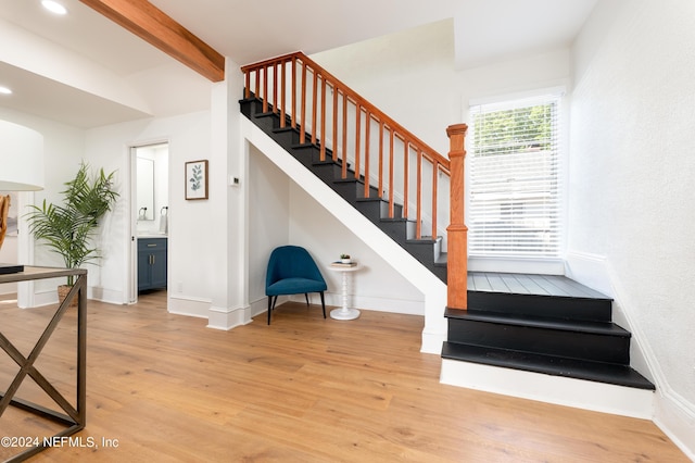 stairway featuring beam ceiling, baseboards, wood finished floors, and recessed lighting