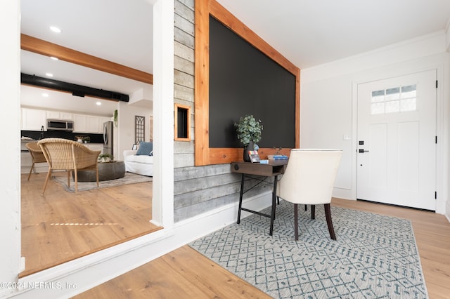 foyer entrance featuring light wood finished floors, beam ceiling, and recessed lighting