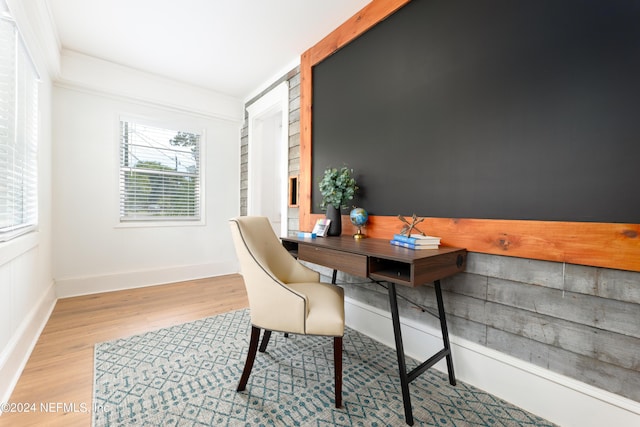 office space featuring baseboards, wood finished floors, and ornamental molding