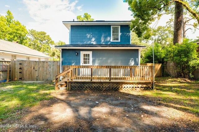 back of house with a deck, a yard, and a fenced backyard