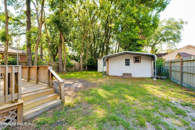 view of yard featuring entry steps, a fenced backyard, and a deck