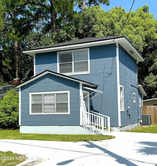 view of front facade featuring fence and cooling unit