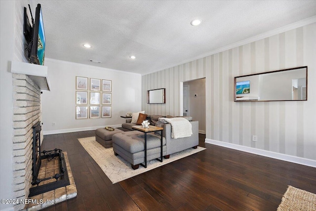 living room featuring a textured ceiling, dark wood-type flooring, a brick fireplace, and crown molding