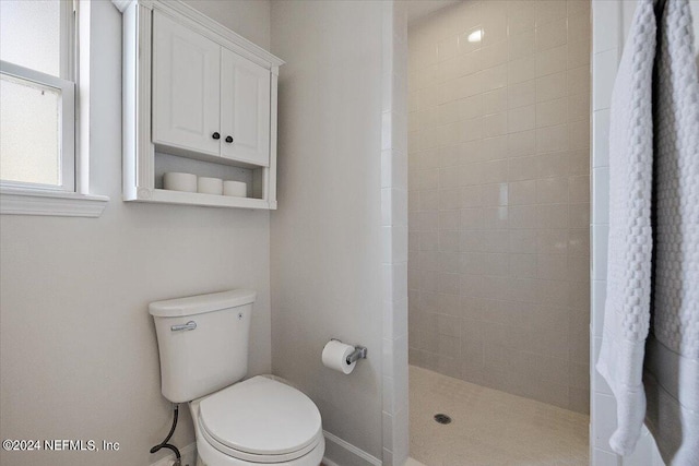 bathroom featuring toilet and walk in shower