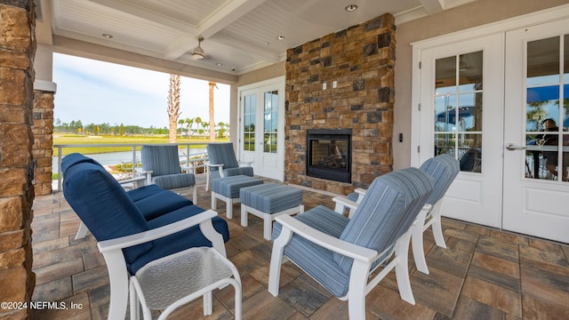 view of patio featuring french doors and an outdoor stone fireplace