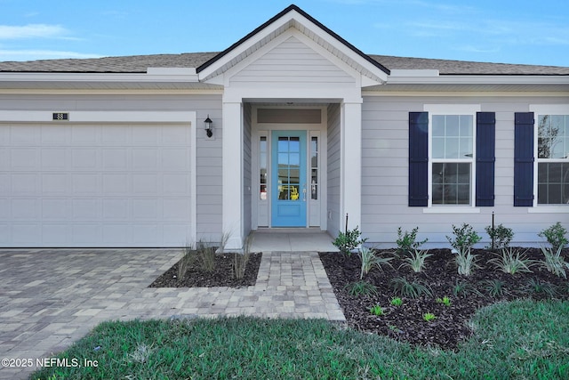 view of exterior entry featuring a garage