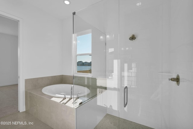 bathroom featuring tile patterned floors and separate shower and tub