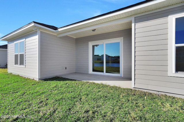 exterior space featuring a patio area and a lawn