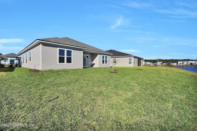 back of property featuring a lawn