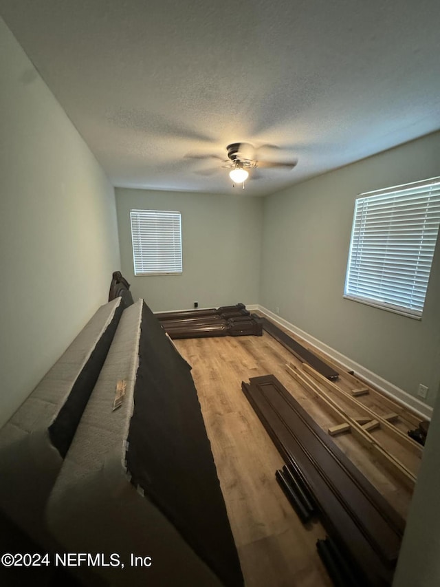 bedroom featuring a textured ceiling, hardwood / wood-style flooring, and ceiling fan