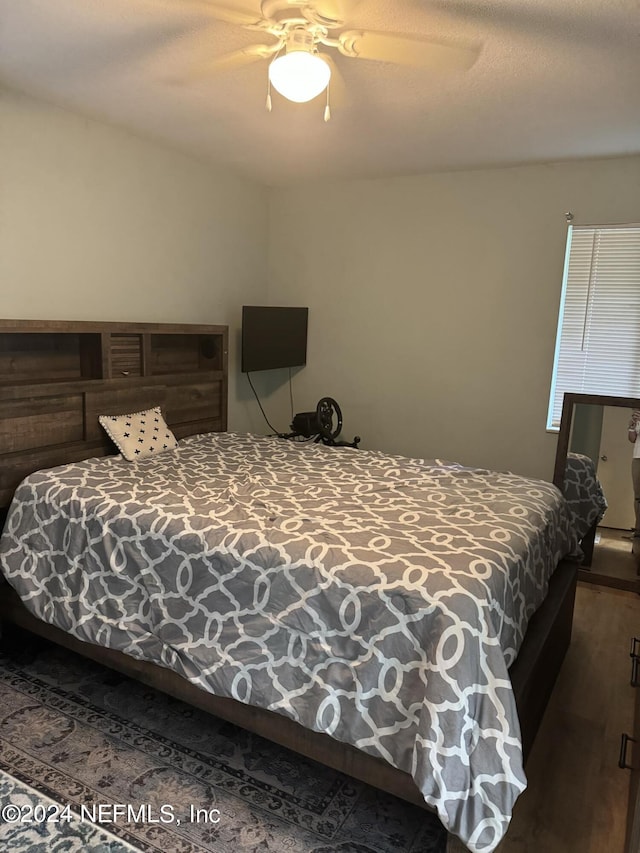 bedroom featuring ceiling fan and dark hardwood / wood-style flooring