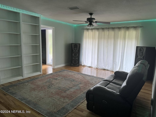 living room featuring hardwood / wood-style flooring and ceiling fan