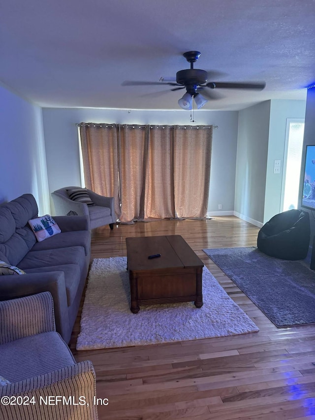 living room with ceiling fan and light hardwood / wood-style floors