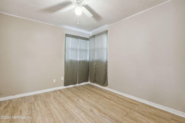 unfurnished room featuring light wood-type flooring, ceiling fan, and a textured ceiling