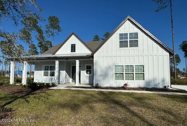 modern farmhouse style home featuring a front yard