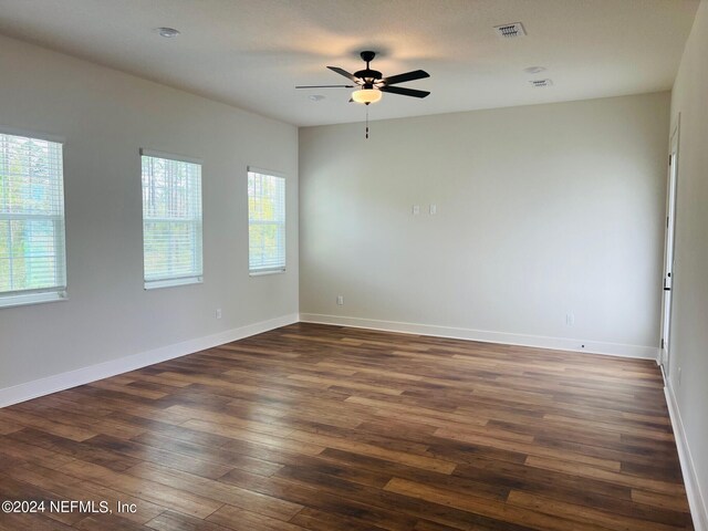 unfurnished room featuring ceiling fan and dark wood-type flooring