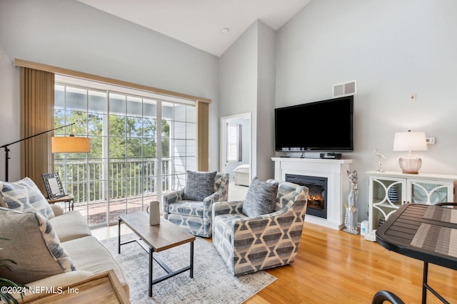 living room featuring hardwood / wood-style floors and high vaulted ceiling