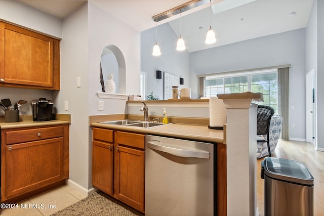 kitchen with pendant lighting, dishwasher, light tile patterned flooring, and sink