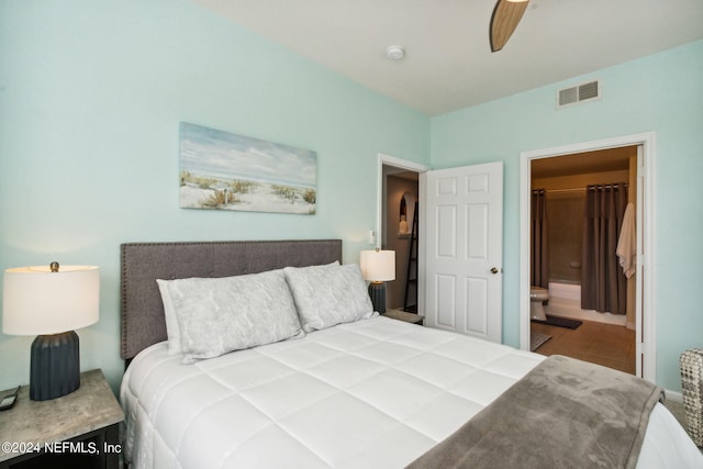 tiled bedroom featuring ensuite bathroom and ceiling fan