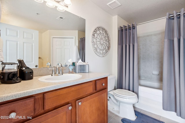 full bathroom with tile patterned floors, shower / bath combo with shower curtain, vanity, and toilet