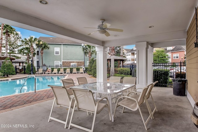 view of patio with a gazebo, ceiling fan, and a community pool