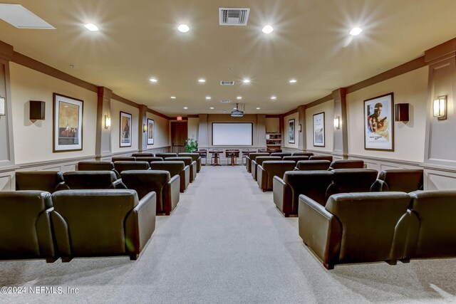 cinema with light carpet and crown molding