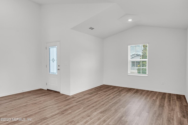 interior space with hardwood / wood-style flooring and vaulted ceiling