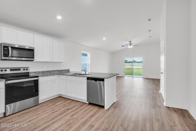 kitchen with white cabinetry, sink, ceiling fan, light hardwood / wood-style floors, and appliances with stainless steel finishes