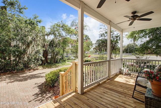 wooden deck featuring ceiling fan and covered porch