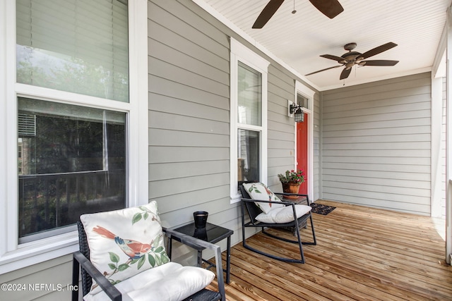 wooden terrace featuring a porch and ceiling fan