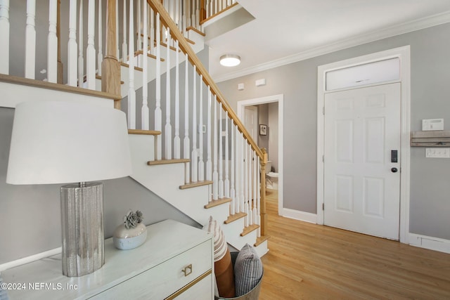 entryway featuring crown molding and hardwood / wood-style floors