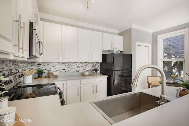 kitchen with tasteful backsplash, stainless steel appliances, sink, and white cabinets