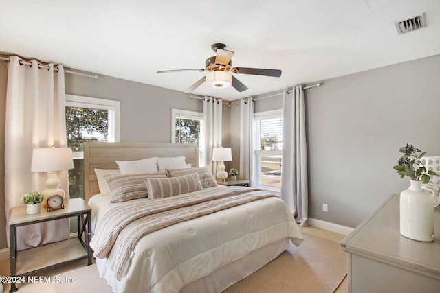 bedroom with light carpet and ceiling fan