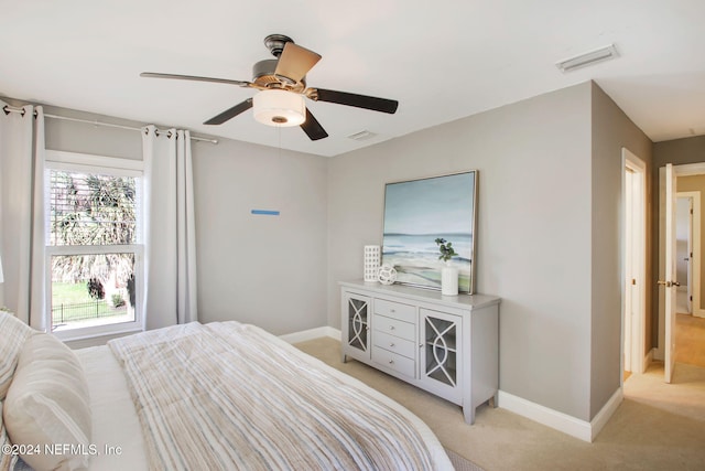 bedroom featuring light carpet and ceiling fan