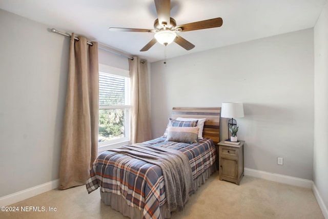 bedroom featuring light colored carpet and ceiling fan