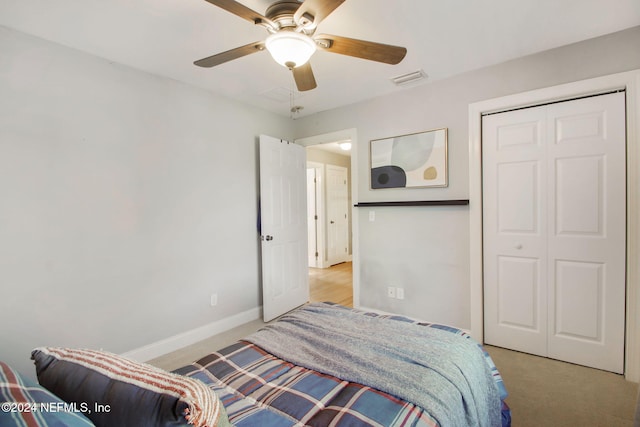 carpeted bedroom featuring a closet and ceiling fan