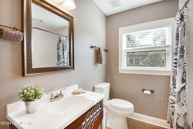 bathroom featuring vanity, toilet, and hardwood / wood-style floors