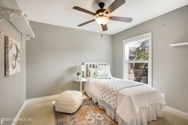 bedroom with ceiling fan and light colored carpet