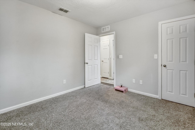 unfurnished bedroom with carpet and a textured ceiling